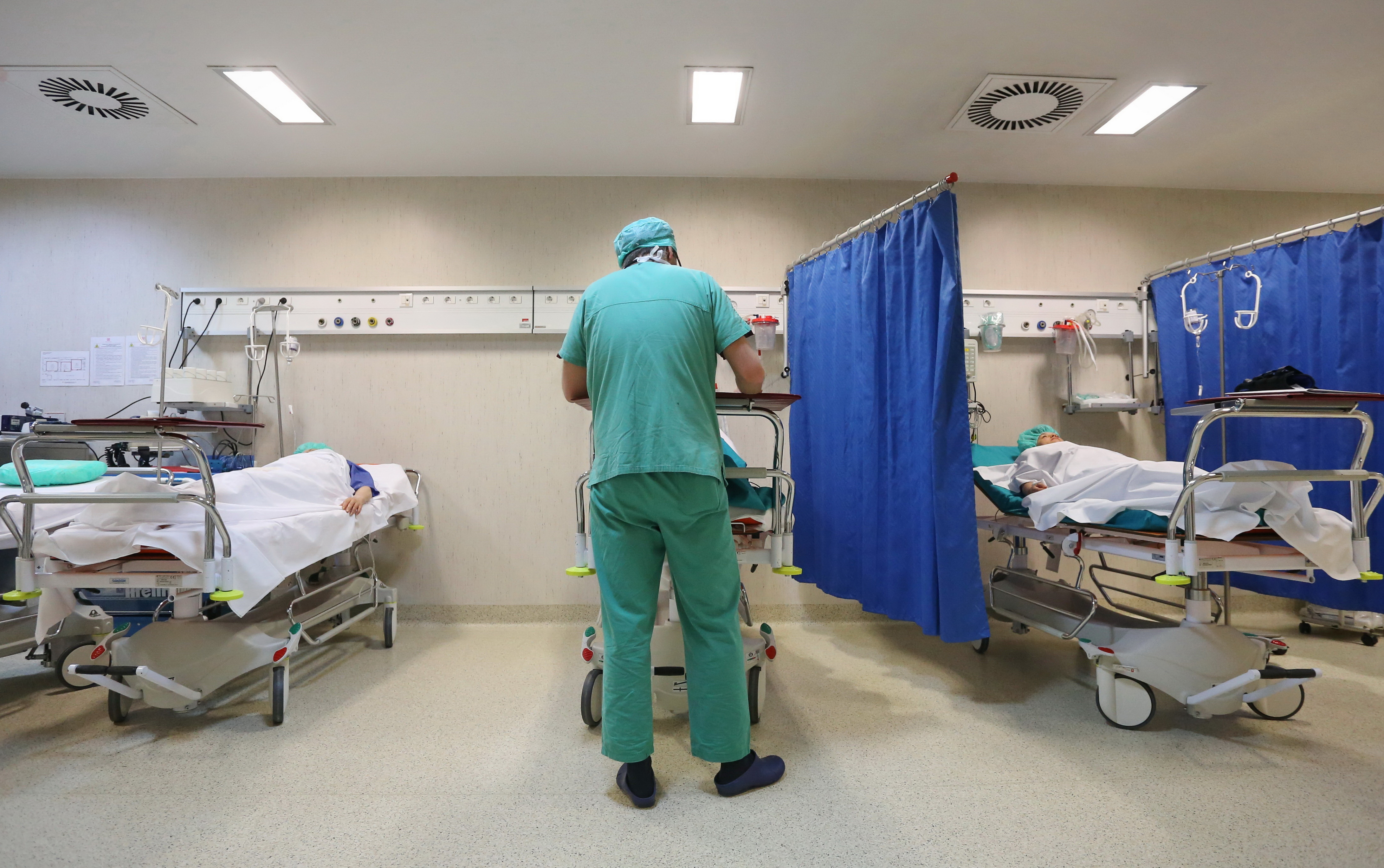 Nurse checking patient records in a ward